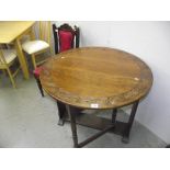 A good oak drop leaf round table with carved detail around edge