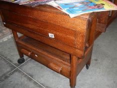 An oak tea trolley with drawer in good clean condition.