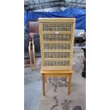 A small wicker 5 drawer chest on stand.