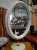 A white painted table mirror.