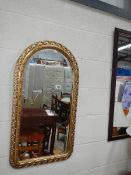 A good oval top bevel edged mirror and one other.