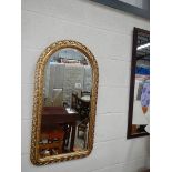 A good oval top bevel edged mirror and one other.