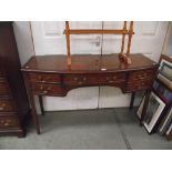 An inlaid darkwood stained bow front chest/sideboard