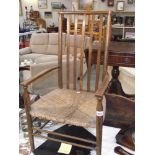 An early 20th century high back country carver chair with reeded seat