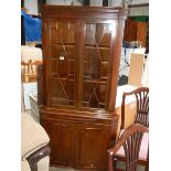 An astragal glazed corner cabinet.