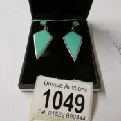 A pair of silver and turquoise drop earrings in the art deco style.