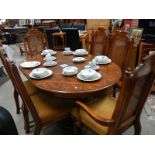 An oak dining table and 4 cane back chairs.