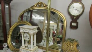 A gilt framed overmantel mirror.