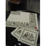 An Austrian table cloth with original tag and 6 matching place mats (in need of cleaning).