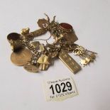 A 9ct gold charm bracelet of 182 grams, including some weight in stones.