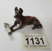 A cold painted bronze dog with bone, signed.