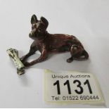 A cold painted bronze dog with bone, signed.