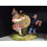 A large continental pottery clown group ornament