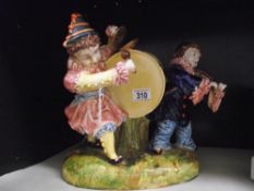 A large continental pottery clown group ornament