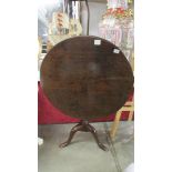 A mahogany circular tip top tripod table, crack to top.