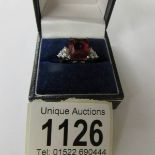 A silver ring set large red stone. Size K.