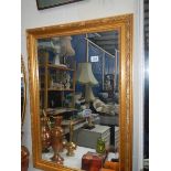 A gilt framed mirror.