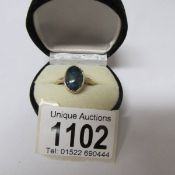 A 9ct gold ring set irridescent stone, size P half, total weight 3.6 grams.