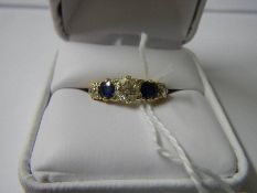A gold ring set 3 diamonds and 2 sapphires size I.
