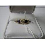 A gold ring set 3 diamonds and 2 sapphires size I.