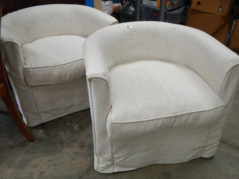 A pair of tub chairs.