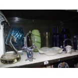 A selection of coloured glass ware including vases and bowls and 3 glass blue bottles