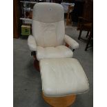A good cream leather chair with stool.
