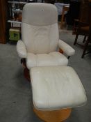 A good cream leather chair with stool.