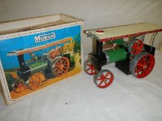 A boxed Mamod steam tractor.