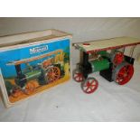 A boxed Mamod steam tractor.