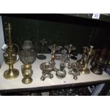 A selection of metal candlesticks, oil lamps etc.