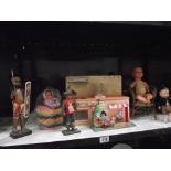 A selection of old dolls including kitchen unit, wicker chair tinplate clockwork toy etc.