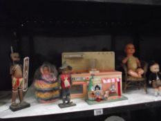 A selection of old dolls including kitchen unit, wicker chair tinplate clockwork toy etc.