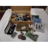 A 1914 WW1 Christmas tin and a box of military buttons, badges, ID tags.