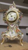 A Dresden porcelain clock with key.