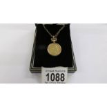 A 1920 gold sovereign in a 9ct gold mount on a 9ct gold chain with safety chain, total weight 19.