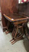 A nest of 3 good quality lyre end tables.