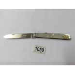 A large silver and mother of pearl folding knife with serrated edge, Sheffiled 1926.