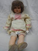 A German porcelain headed doll with 'Mama'.