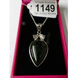 A silver and hard stone pear shaped necklace.
