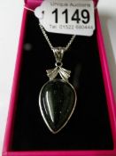 A silver and hard stone pear shaped necklace.