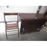 A dark wood effect dining table with 4 folding chairs inside, (collect only).