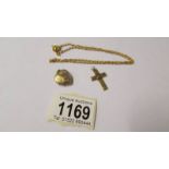 A yellow metal chain, locket and cross (all test as gold).