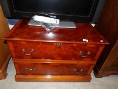 A walnut veneered faux two drawer TV stand with drop down front.