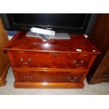 A walnut veneered faux two drawer TV stand with drop down front.