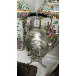 A silver plate kettle on stand.