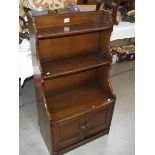 A dark oak book case with cupboard. (collect only).