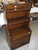 A dark oak book case with cupboard. (collect only).