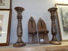 A pair of religious wooden wall candle holders and 2 large wooden candle holders.