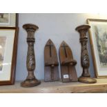 A pair of religious wooden wall candle holders and 2 large wooden candle holders.